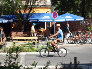Cycling on a small bike with cool hat